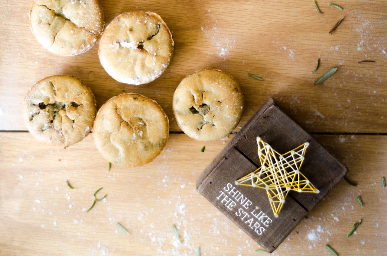 Crafting Captivating Headlines: Your awesome post title goes here A set of homemade mini pies on a wooden surface with a star decoration and inspirational text.